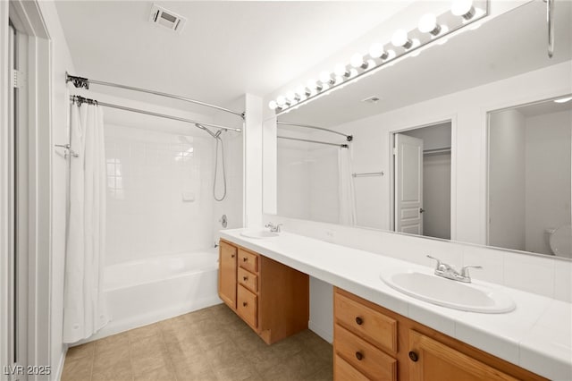 bathroom with shower / bath combo, visible vents, a sink, and double vanity