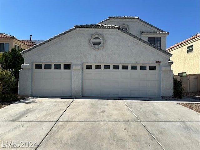 garage with concrete driveway