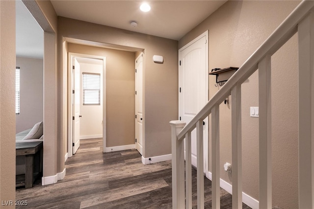 foyer with dark wood-style floors, stairway, and baseboards