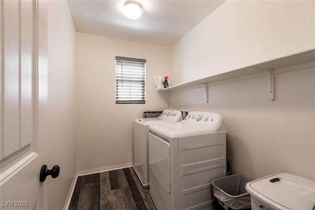 washroom featuring baseboards, laundry area, washer and clothes dryer, and dark wood-style flooring