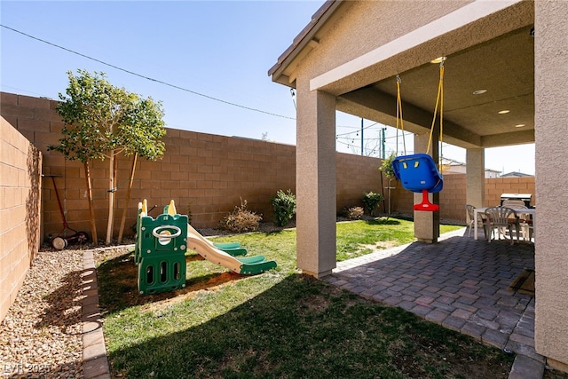 view of patio / terrace featuring a playground and a fenced backyard