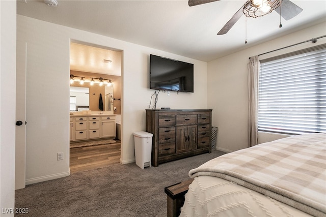 carpeted bedroom featuring a ceiling fan, baseboards, and ensuite bathroom