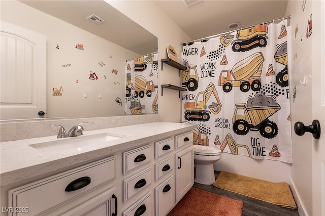 full bath featuring toilet, visible vents, and vanity