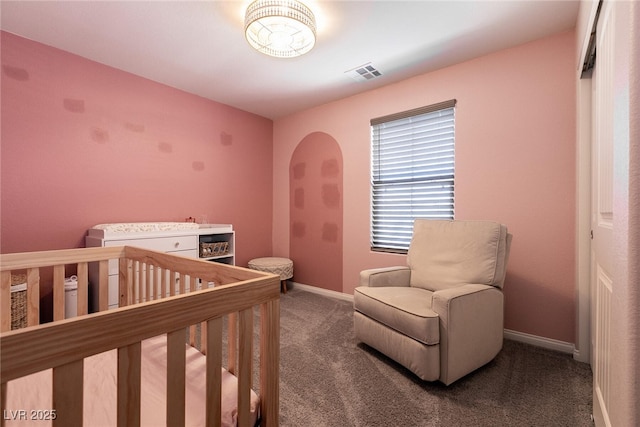 carpeted bedroom featuring a crib, visible vents, and baseboards