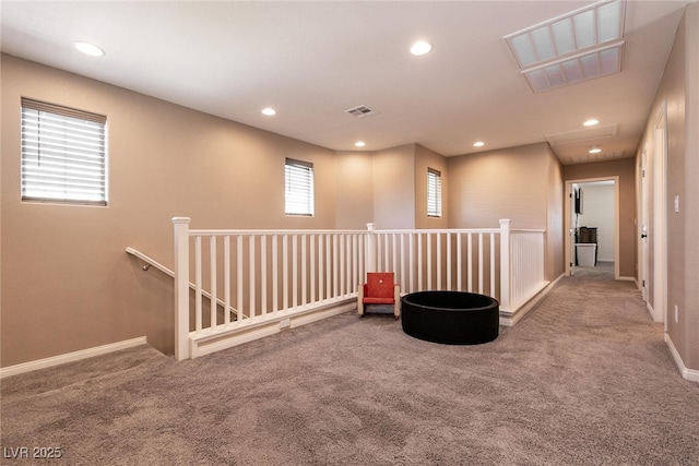 interior space with recessed lighting, visible vents, and an upstairs landing