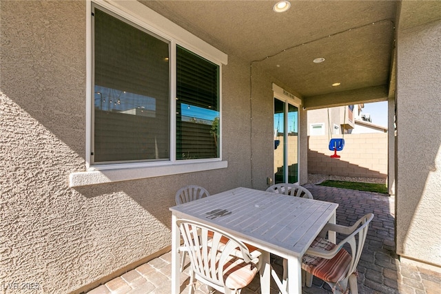 view of patio with outdoor dining space and fence