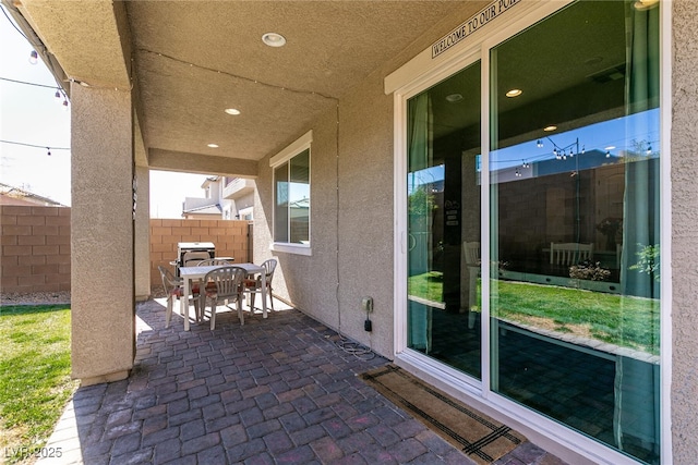 view of patio / terrace with outdoor dining space and fence