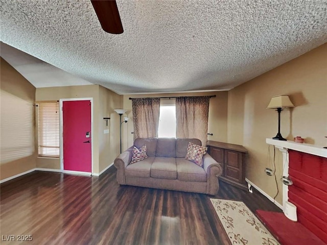 living area with a textured ceiling, plenty of natural light, wood finished floors, and baseboards