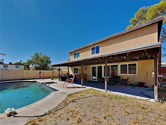 view of swimming pool featuring a patio area, fence, and a fenced in pool