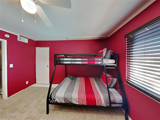 bedroom with a ceiling fan, carpet, visible vents, and ornamental molding