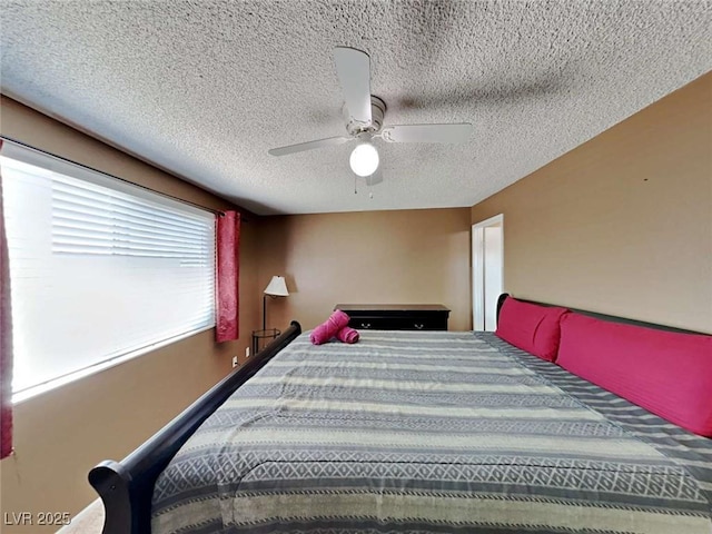 bedroom featuring a textured ceiling and a ceiling fan