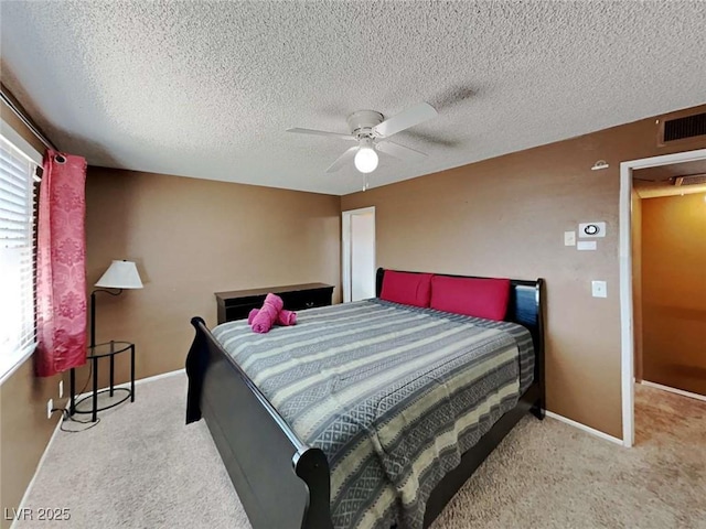 bedroom with visible vents, baseboards, ceiling fan, carpet, and a textured ceiling