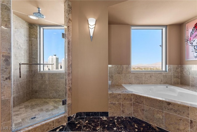 bathroom featuring a stall shower and a garden tub