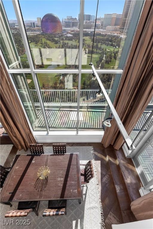 balcony with a view of city and outdoor dining area