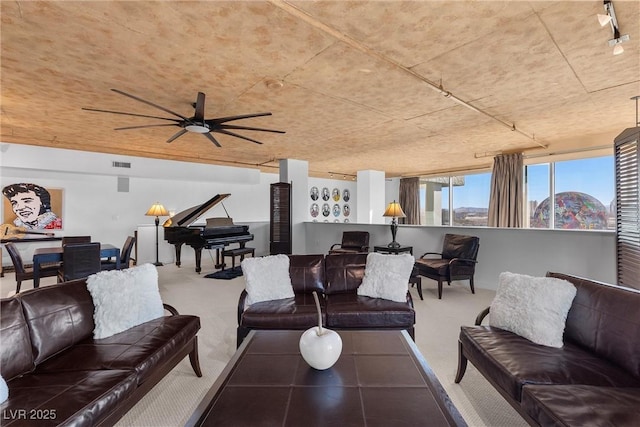 living room with carpet floors, visible vents, and a ceiling fan