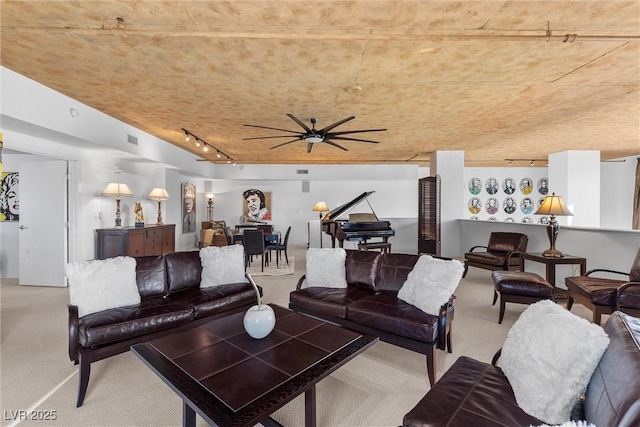 living room with carpet, visible vents, and track lighting