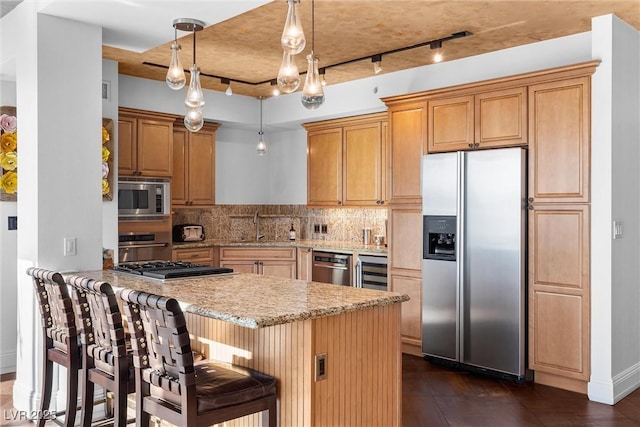 kitchen with wine cooler, stainless steel appliances, a sink, backsplash, and light stone countertops