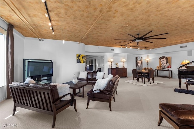 living room with light colored carpet, ceiling fan, visible vents, and track lighting