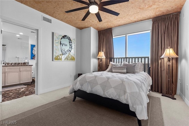 bedroom with visible vents, light carpet, ceiling fan, ensuite bath, and baseboards