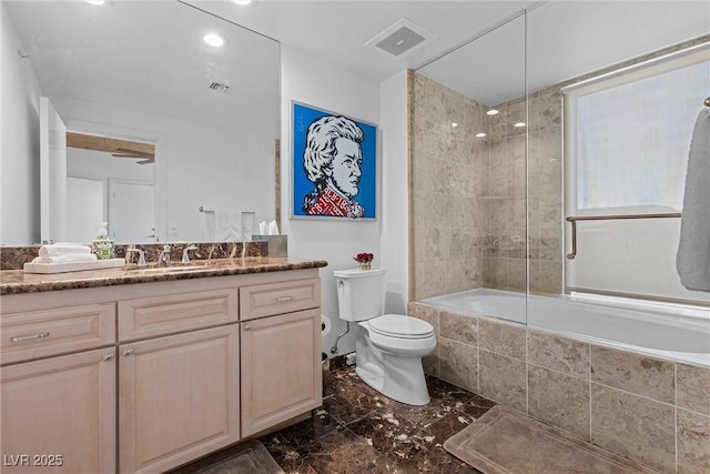 full bathroom with toilet, vanity, visible vents, tiled shower / bath, and marble finish floor