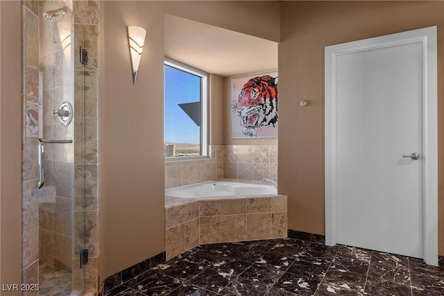 full bath with marble finish floor, a shower stall, and a bath