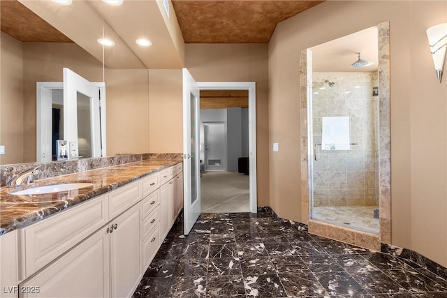 full bathroom with a stall shower, marble finish floor, and vanity