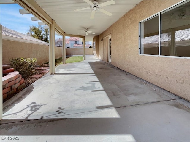 view of patio featuring a ceiling fan and fence