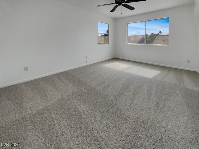 empty room with a ceiling fan, baseboards, and carpet flooring