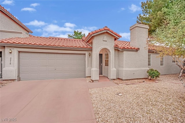 mediterranean / spanish-style home featuring an attached garage, driveway, a chimney, and stucco siding