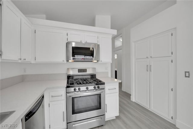 kitchen featuring appliances with stainless steel finishes and white cabinetry