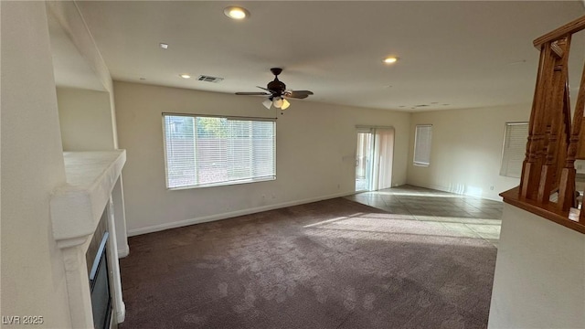 unfurnished living room with recessed lighting, visible vents, a ceiling fan, carpet flooring, and baseboards