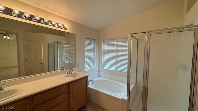 full bath featuring a stall shower, lofted ceiling, a sink, and a bath