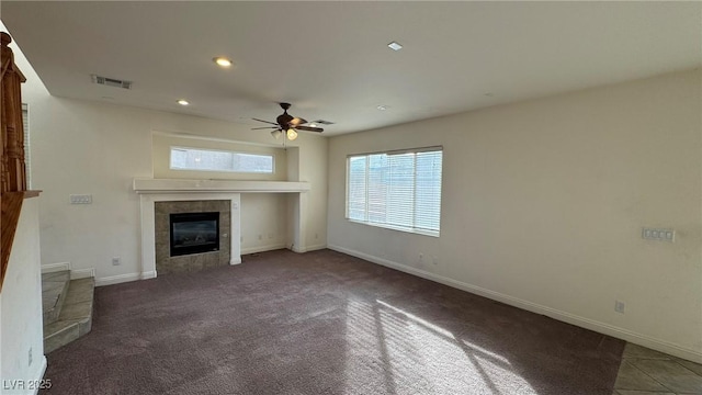 unfurnished living room with ceiling fan, a tile fireplace, recessed lighting, visible vents, and baseboards