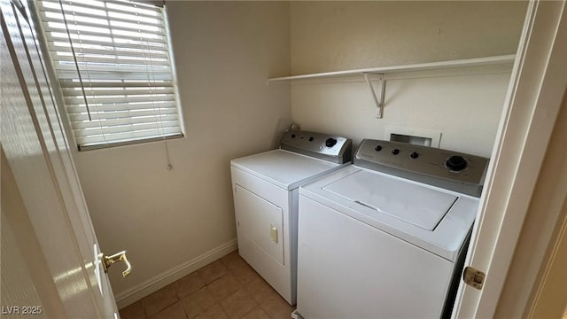 laundry room featuring laundry area, light tile patterned floors, baseboards, and separate washer and dryer