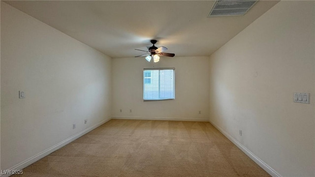 unfurnished room featuring a ceiling fan, light colored carpet, visible vents, and baseboards