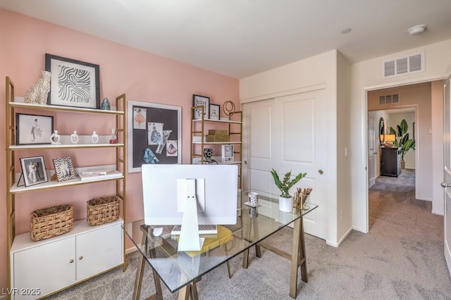 office area with carpet floors, visible vents, and baseboards