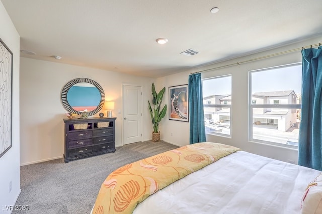 carpeted bedroom with baseboards and visible vents