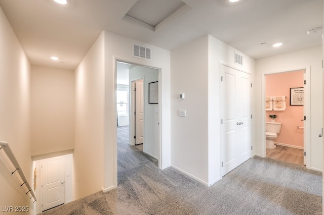 hallway featuring carpet, visible vents, and recessed lighting