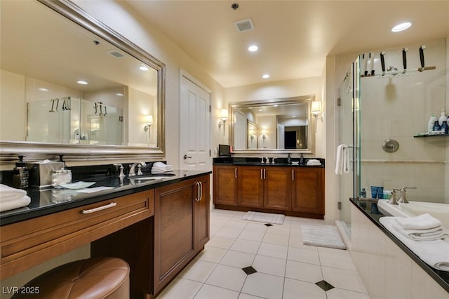 bathroom with recessed lighting, visible vents, a sink, and a shower stall