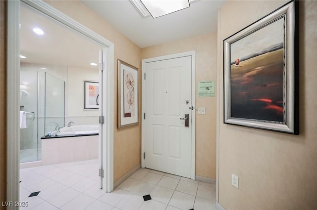 foyer with recessed lighting, light tile patterned flooring, and baseboards