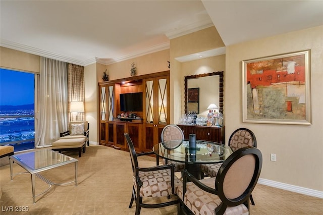 dining space with crown molding and baseboards