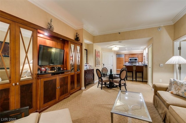 living area with crown molding and baseboards