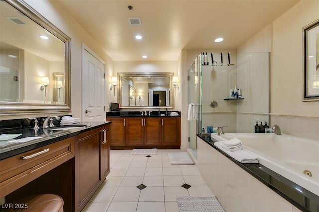 bathroom featuring a garden tub, tile patterned flooring, a shower stall, a sink, and recessed lighting