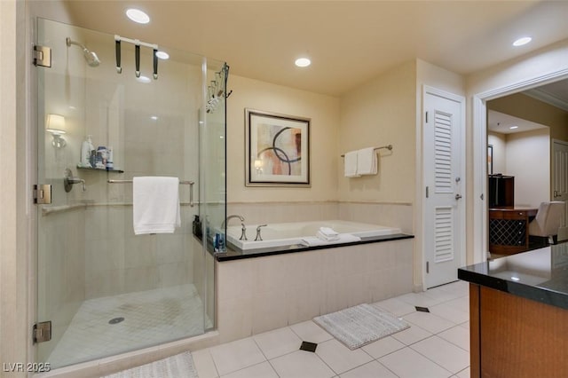 bathroom with a stall shower, a garden tub, and tile patterned floors