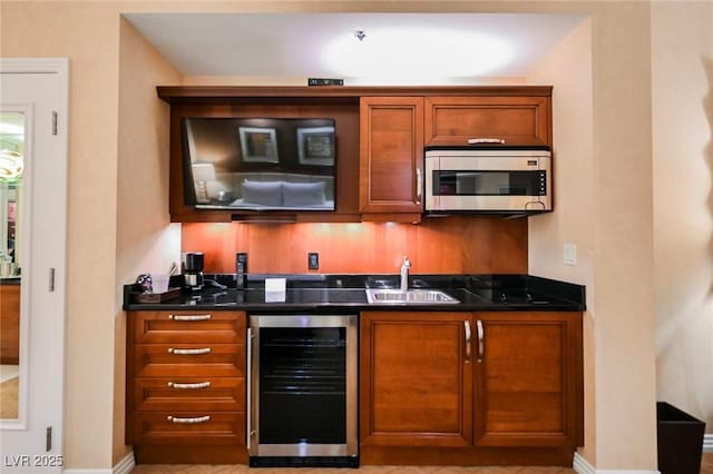 bar featuring indoor wet bar, wine cooler, stainless steel microwave, and a sink