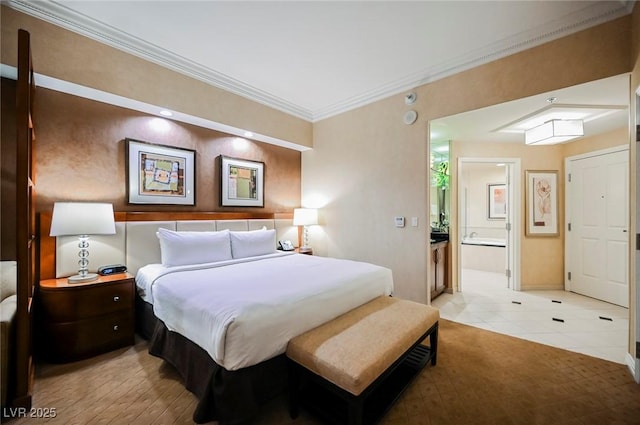 bedroom featuring baseboards, ornamental molding, and connected bathroom