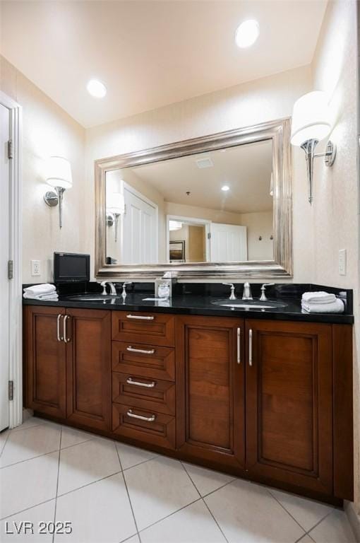 bathroom featuring double vanity, tile patterned flooring, and a sink