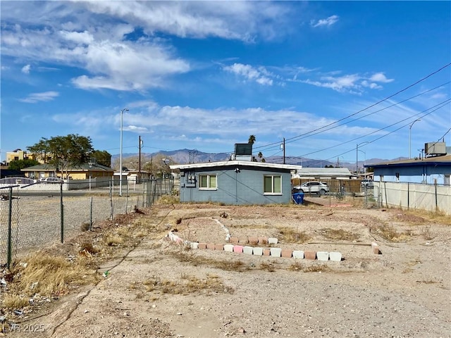 exterior space with fence and a mountain view