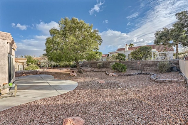 view of yard with fence and a patio