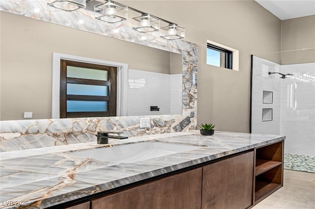 full bath featuring vanity and walk in shower